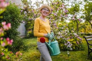 Portrait of happy senior woman gardening. photo