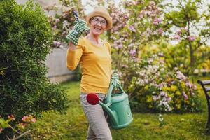 Portrait of happy senior woman gardening. photo
