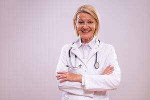 Portrait of mature female doctor on gray background. photo