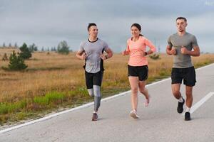 A group of friends, athletes, and joggers embrace the early morning hours as they run through the misty dawn, energized by the rising sun and surrounded by the tranquil beauty of nature photo