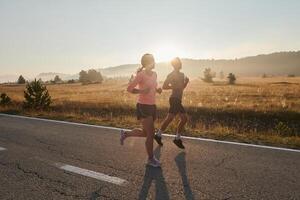 Energized by the beauty of nature, a couple powers through their morning run, their bodies and spirits invigorated. photo