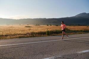 Determined Dawn. Confident and Motivated Athlete Embarks on Sunrise Run. photo