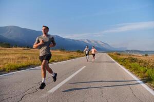 A group of friends maintains a healthy lifestyle by running outdoors on a sunny day, bonding over fitness and enjoying the energizing effects of exercise and nature photo