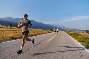 A group of friends maintains a healthy lifestyle by running outdoors on a sunny day, bonding over fitness and enjoying the energizing effects of exercise and nature photo