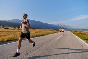 A group of friends maintains a healthy lifestyle by running outdoors on a sunny day, bonding over fitness and enjoying the energizing effects of exercise and nature photo