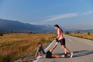 Morning Stretch. Romantic Couple Prepares for Early Morning Run photo