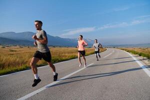 A group of friends maintains a healthy lifestyle by running outdoors on a sunny day, bonding over fitness and enjoying the energizing effects of exercise and nature photo