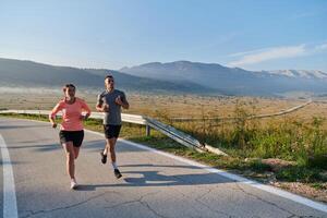 Energized by the beauty of nature, a couple powers through their morning run, their bodies and spirits invigorated. photo