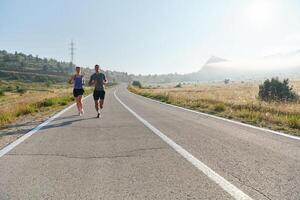 Energized by the beauty of nature, a couple powers through their morning run, their bodies and spirits invigorated. photo