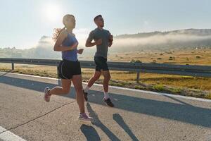 Energized by the beauty of nature, a couple powers through their morning run, their bodies and spirits invigorated. photo