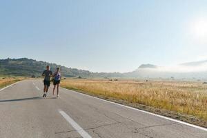 Energized by the beauty of nature, a couple powers through their morning run, their bodies and spirits invigorated. photo