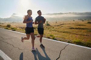 Energized by the beauty of nature, a couple powers through their morning run, their bodies and spirits invigorated. photo