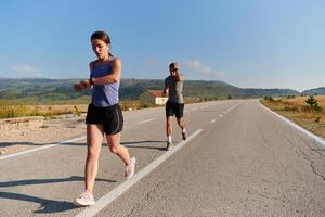 Energized by the beauty of nature, a couple powers through their morning run, their bodies and spirits invigorated. photo