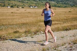 A determined woman athlete trains for success in the morning sun. photo