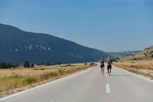 Energized by the beauty of nature, a couple powers through their morning run, their bodies and spirits invigorated. photo