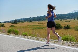 A determined woman athlete trains for success in the morning sun. photo