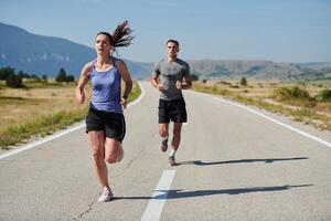 Energized by the beauty of nature, a couple powers through their morning run, their bodies and spirits invigorated. photo