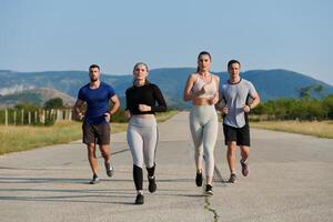 A group of friends maintains a healthy lifestyle by running outdoors on a sunny day, bonding over fitness and enjoying the energizing effects of exercise and nature photo