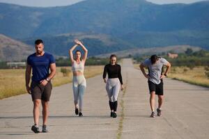 A group of friends maintains a healthy lifestyle by running outdoors on a sunny day, bonding over fitness and enjoying the energizing effects of exercise and nature photo