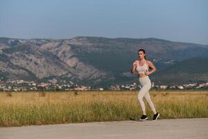 A determined woman athlete trains for success in the morning sun. photo