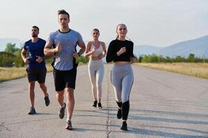 A group of friends maintains a healthy lifestyle by running outdoors on a sunny day, bonding over fitness and enjoying the energizing effects of exercise and nature photo