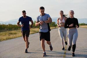 A group of friends maintains a healthy lifestyle by running outdoors on a sunny day, bonding over fitness and enjoying the energizing effects of exercise and nature photo