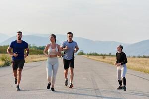 A group of friends maintains a healthy lifestyle by running outdoors on a sunny day, bonding over fitness and enjoying the energizing effects of exercise and nature photo