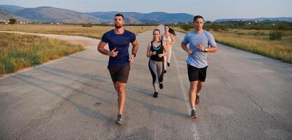 A group of friends maintains a healthy lifestyle by running outdoors on a sunny day, bonding over fitness and enjoying the energizing effects of exercise and nature photo