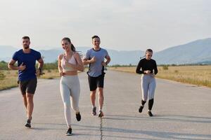 A group of friends maintains a healthy lifestyle by running outdoors on a sunny day, bonding over fitness and enjoying the energizing effects of exercise and nature photo