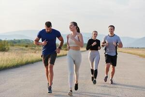 A group of friends maintains a healthy lifestyle by running outdoors on a sunny day, bonding over fitness and enjoying the energizing effects of exercise and nature photo