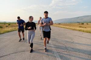 A group of friends maintains a healthy lifestyle by running outdoors on a sunny day, bonding over fitness and enjoying the energizing effects of exercise and nature photo