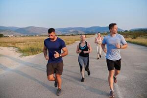 A group of friends maintains a healthy lifestyle by running outdoors on a sunny day, bonding over fitness and enjoying the energizing effects of exercise and nature photo