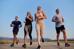 A group of friends maintains a healthy lifestyle by running outdoors on a sunny day, bonding over fitness and enjoying the energizing effects of exercise and nature photo