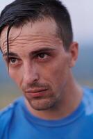 Post-Run Repose. Sweaty Athlete Rests After Intense Daily Run. photo