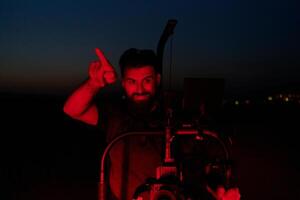 Nighttime Capture. Professional Videographer Films Athletes Running in Red-Lit Darkness photo