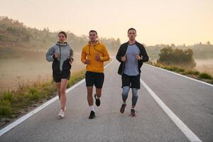 Running towards a common goal, a group of colleagues braves the misty morning air, their determination evident in every stride. photo