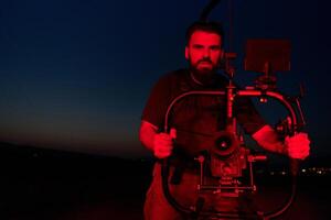 Nighttime Capture. Professional Videographer Films Athletes Running in Red-Lit Darkness photo