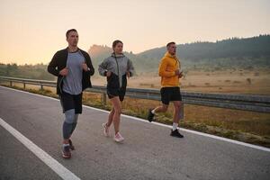 Running towards a common goal, a group of colleagues braves the misty morning air, their determination evident in every stride. photo