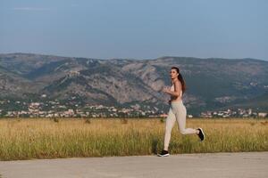 A determined woman athlete trains for success in the morning sun. photo