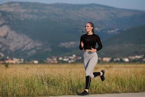 A determined woman athlete trains for success in the morning sun. photo