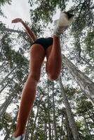 Adventurous Woman Overcoming Forest Obstacles with Determination and Agility. photo