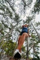 Adventurous Woman Overcoming Forest Obstacles with Determination and Agility. photo