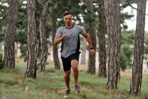 Determined Man Conquering Forest Obstacles with Grit and Speed photo