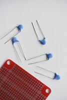 Red printed circuit board and chips and radio components. Capacitors and transistors. photo