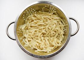 Boiled noodles in a colander for cooking. photo