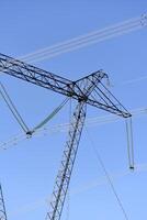 The construction of a high-voltage power line in close-up. Wires on a blue sky background. photo