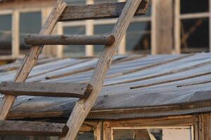 An old wooden staircase tilted onto the barn. Wooden stairs in the village. photo