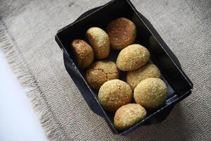 Sweet sesame cookies in cardboard boxes on burlap. Cookies in a box. photo