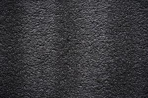 Black porous porous foam background. Background texture of black foam rubber photo