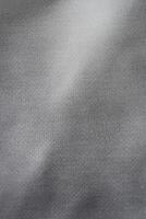 Silver background of aluminum foil. Grey ribbed background. photo